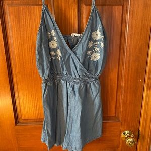 Denim romper with floral accent size medium